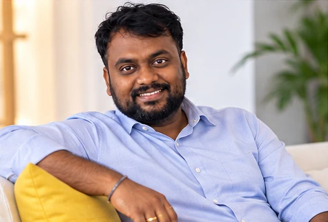 Veera Sanaka seated in a relaxed office setting
